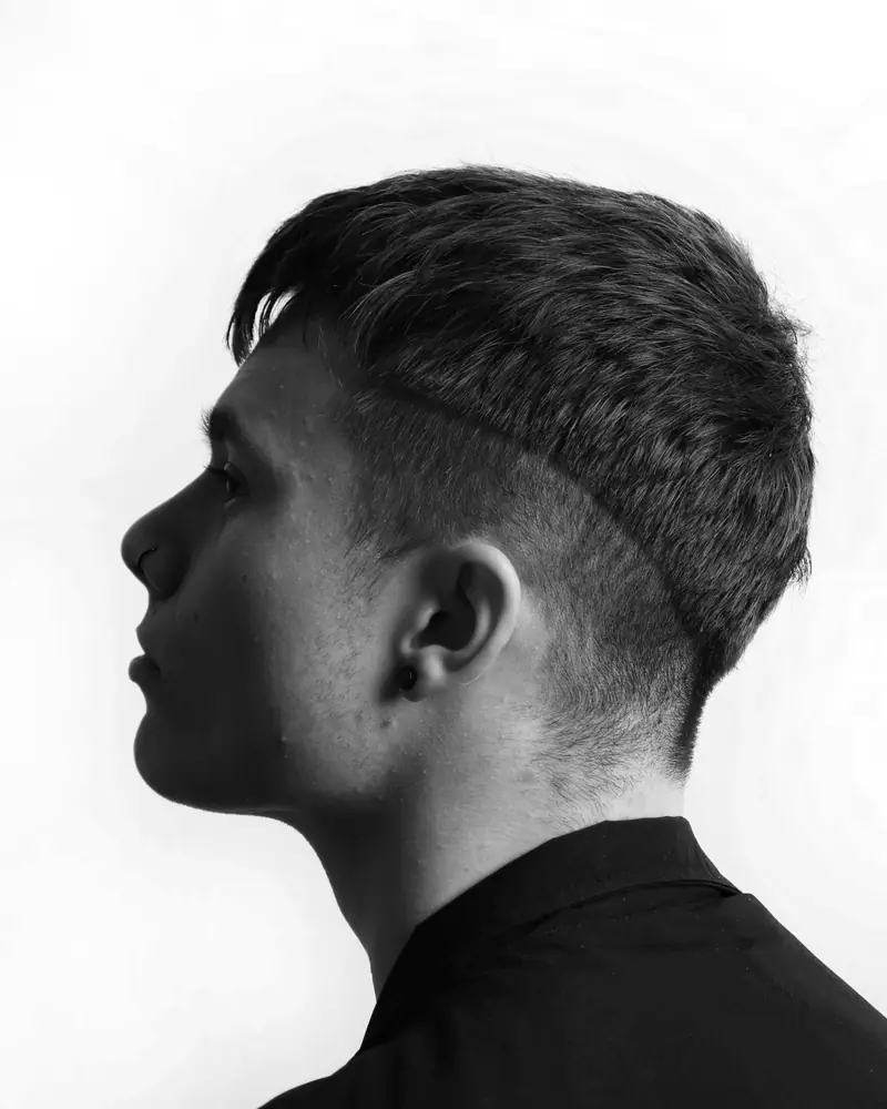 Callum Reid in profile, with a short textured crop